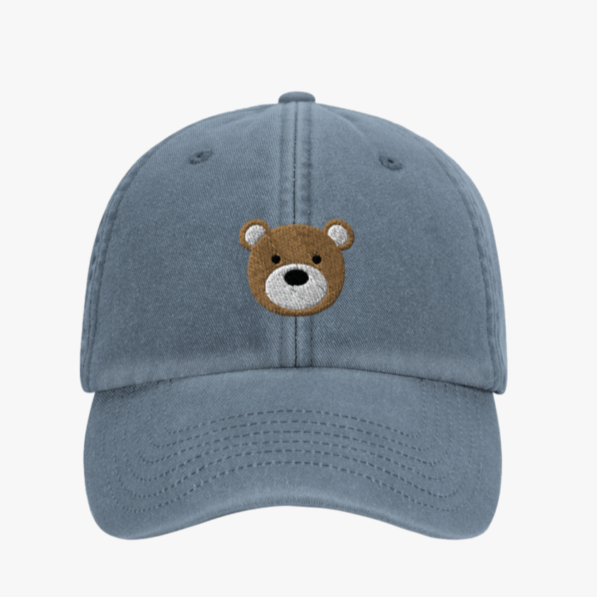 Blue cap with a bear face embroidery on a white background