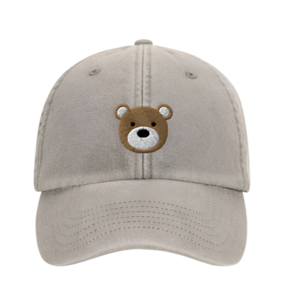 Beige cap with a bear face emblem on a white background