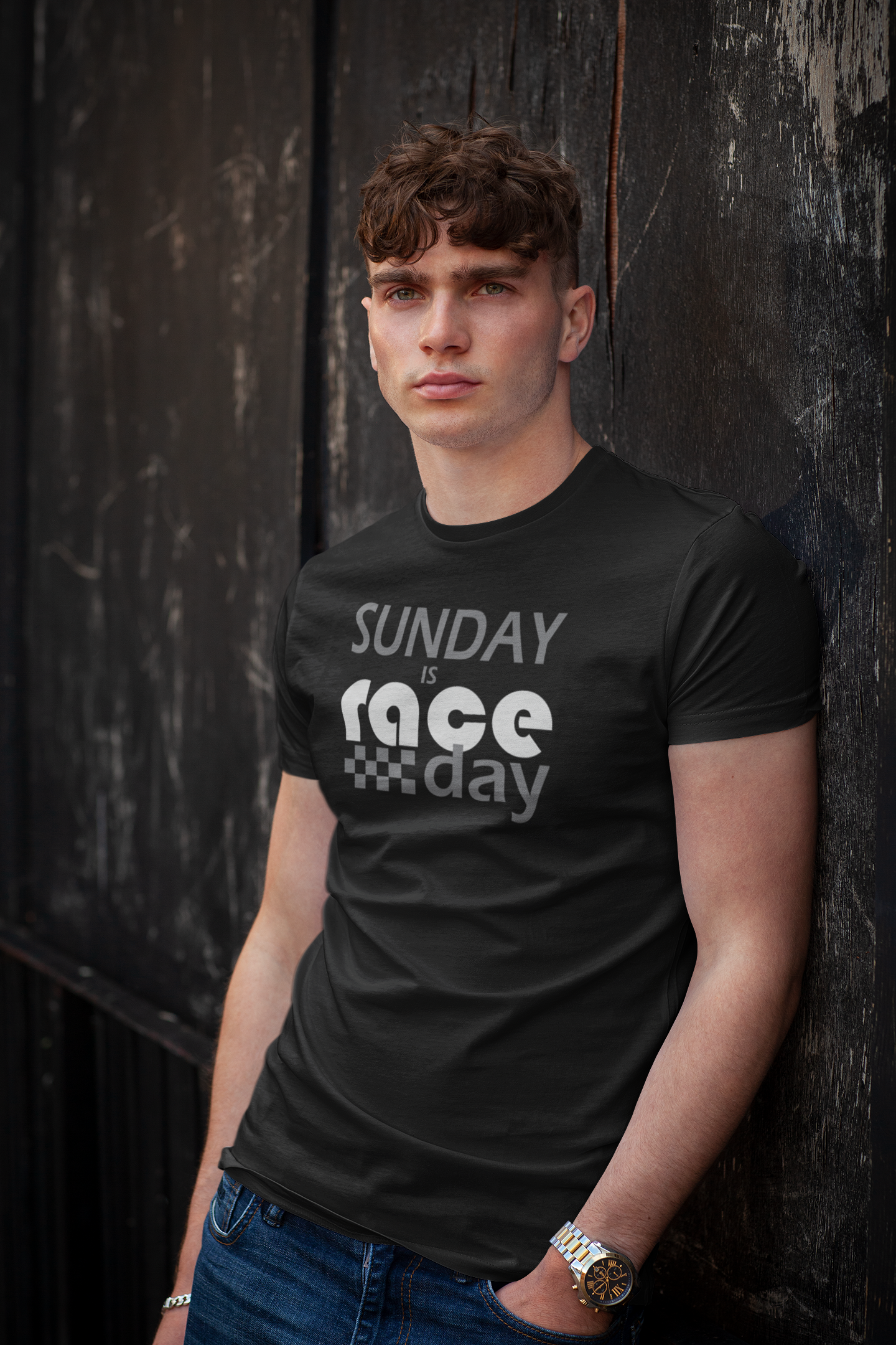 Man wearing a black t-shirt with 'Sunday is race day' text against a dark background